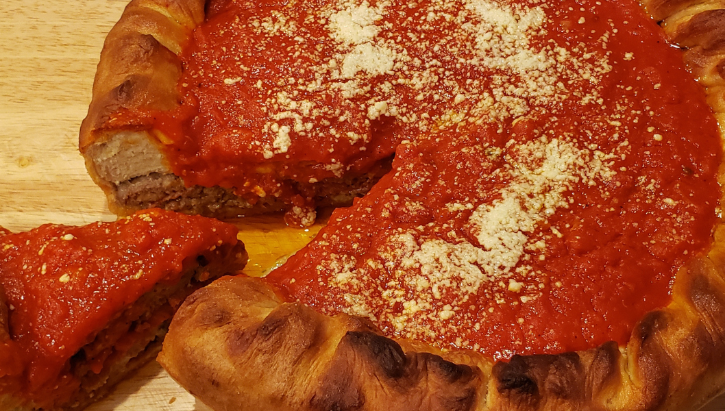 Stuffed pizza with slice cut out