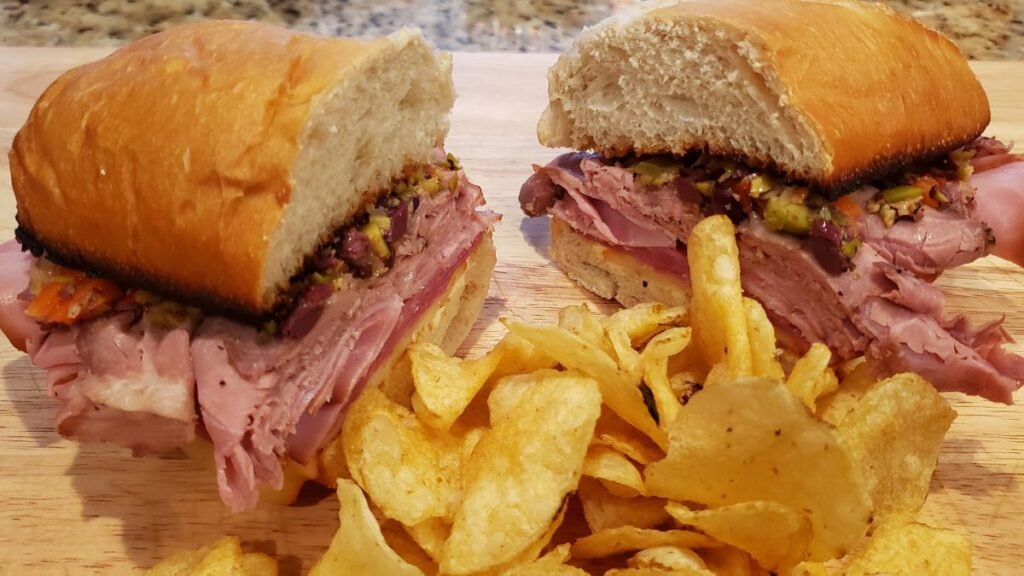 hero sandwich with olive spread and chips