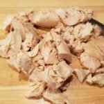 rotisserie chicken breast cut on a cutting board