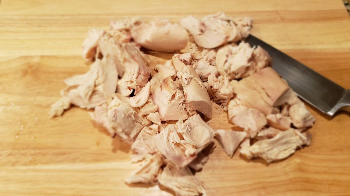 rotisserie chicken breast cut on a cutting board