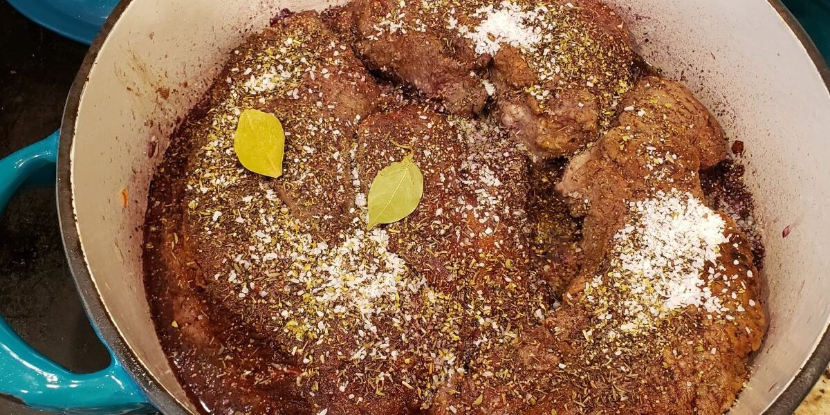 seasonings and beef in red wine reduction