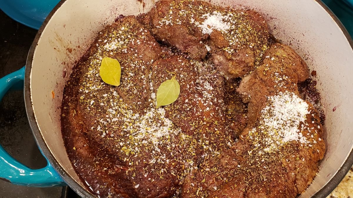 seasonings and beef in red wine reduction