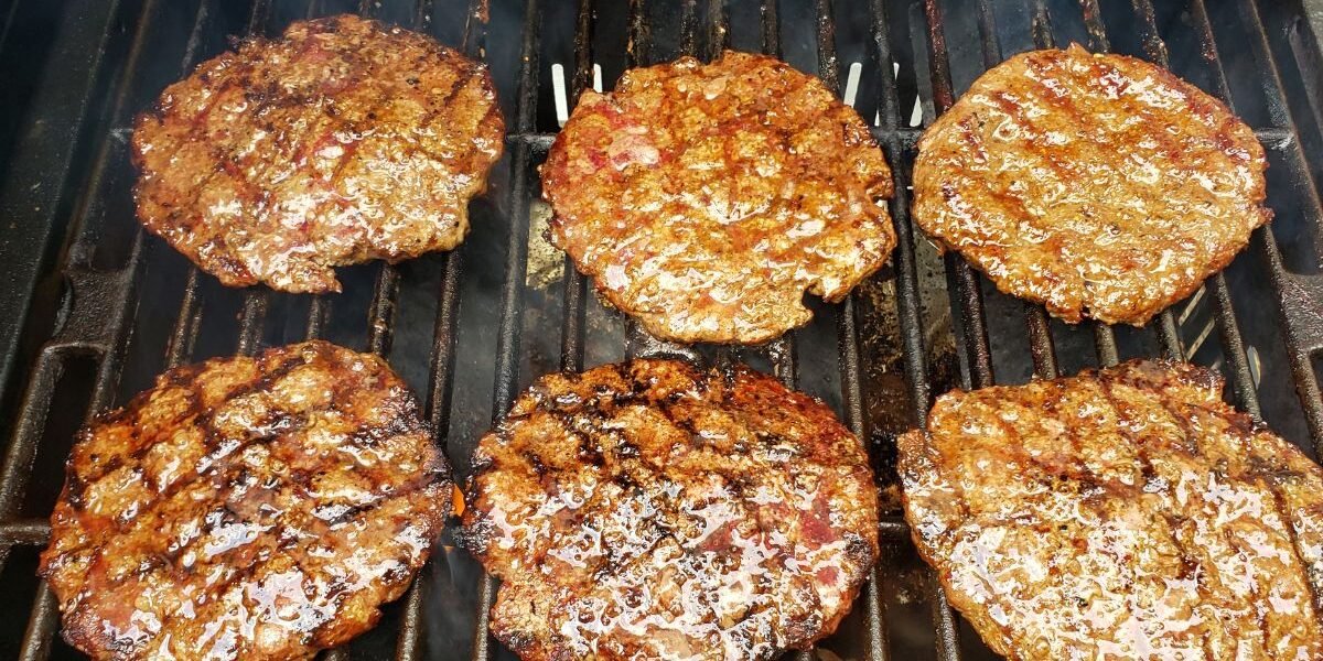 six burgers on a grill