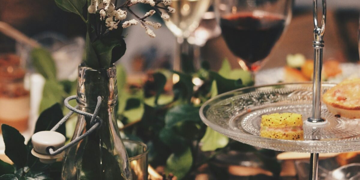 clear glass 2-tier plate beside flower arrangement