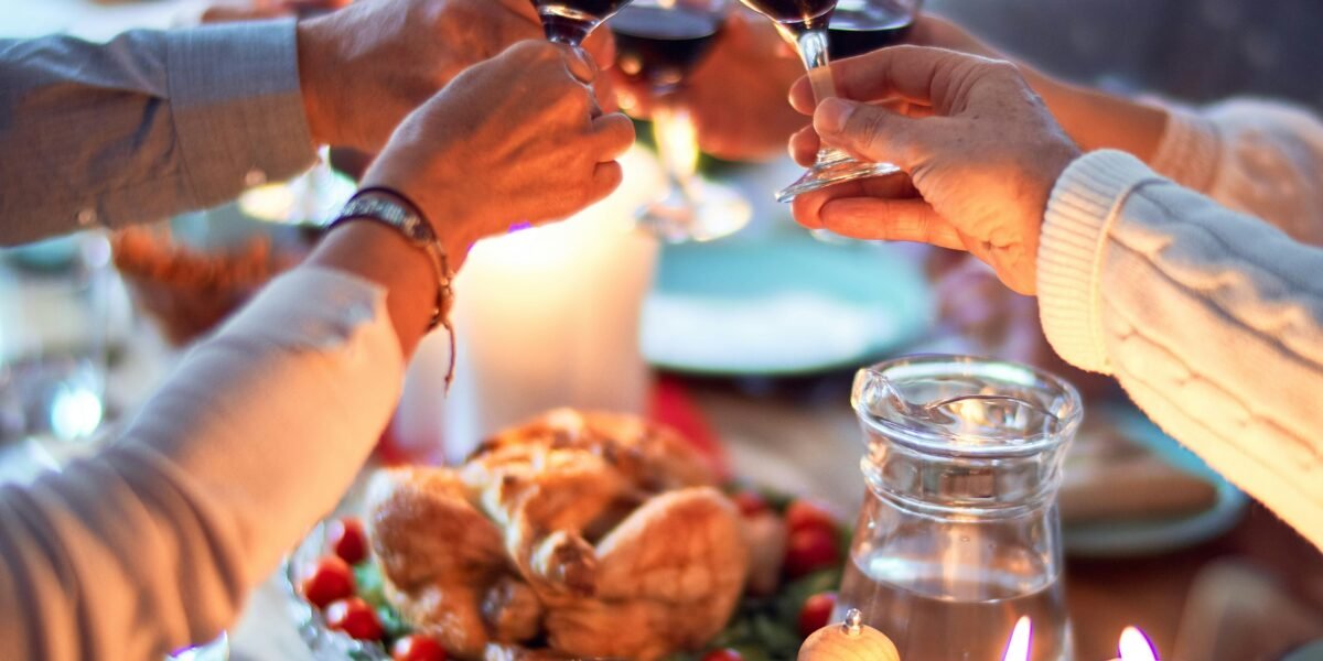 woman in white long sleeve shirt holding wine glass